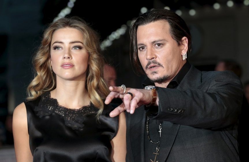 Johnny Depp and his actress wife Amber Heard arrive for the premiere of the British film ''Black Mass'' in London, Britain October 11, 2015. REUTERS/Suzanne Plunkett/