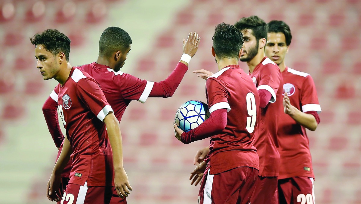 Qatar Olympic team players celebrate a goal against Hong Kong during their friendly game in Doha on Tuesday night. 