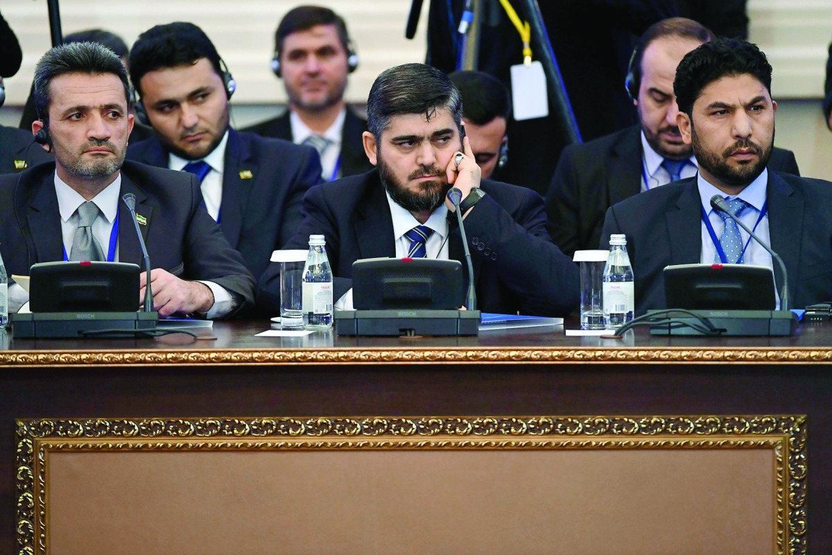 Chief Opposition Negotiator Mohammad Alloush (centre) of the Jaish Al Islam (Army of Islam) rebel group attends the first session of Syria peace talks at Astana's Rixos President Hotel, yesterday.