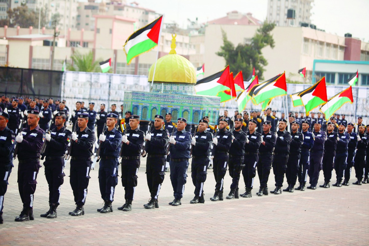 Newly graduated police officers attend a parade holding Dome of the Rock model, during their graduation ceremony organised by the Palestinian Government in Gaza City, yesterday.