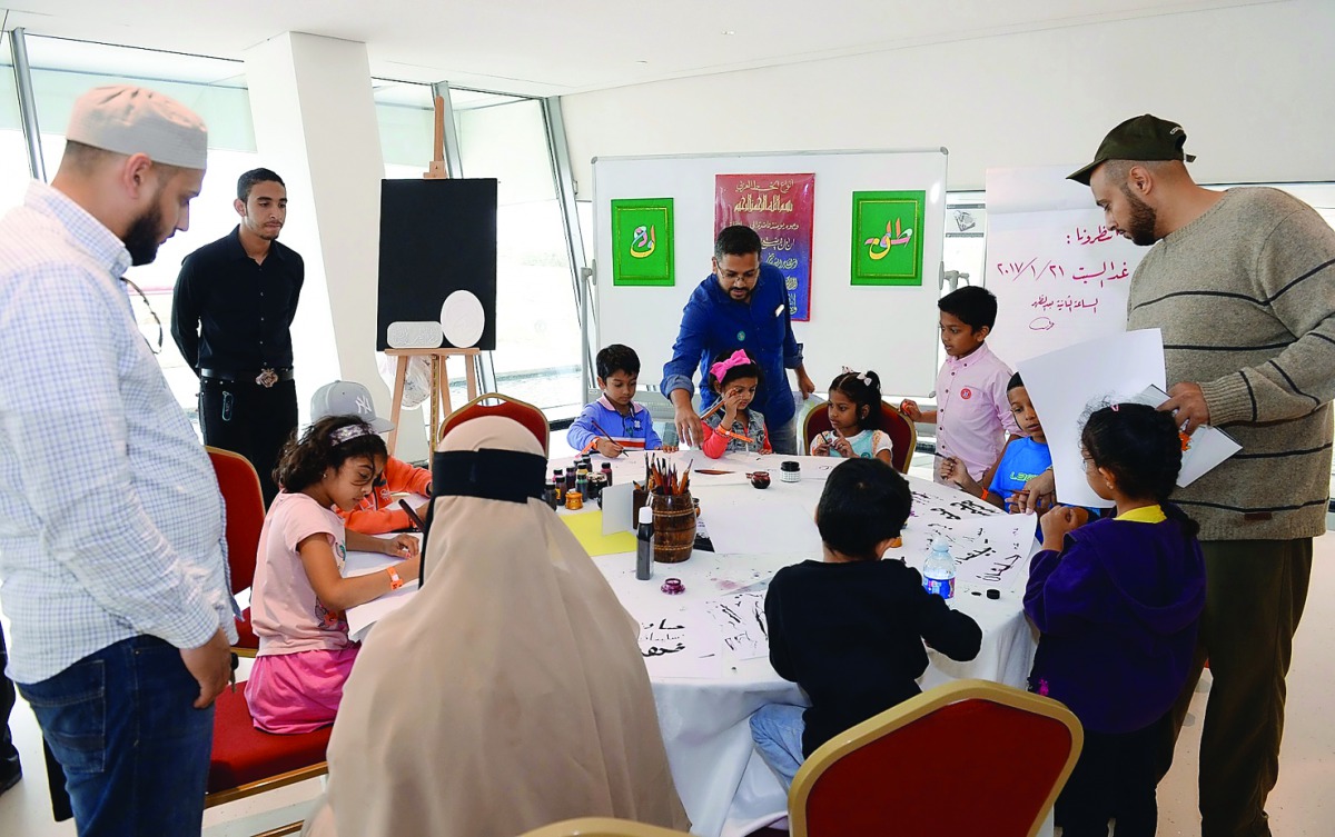 Children participate in an Arabic calligraphy workshop held as part of the ‘The Beacon of Knowledge and Light’ festival.