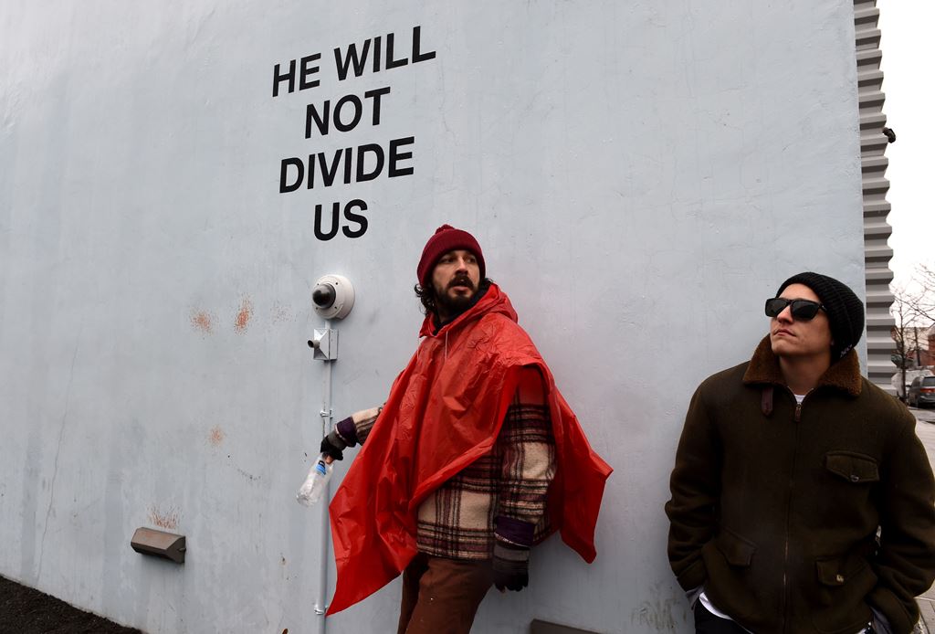 US actor Shia LaBeouf (L) is seen during his 'He Will Not Divide Us' livestream outside the Museum of the Moving Image in Astoria, in the Queens borough of New York January 24, 2017 as a protest against President Donald Trump. AFP / TIMOTHY A. CLARY
