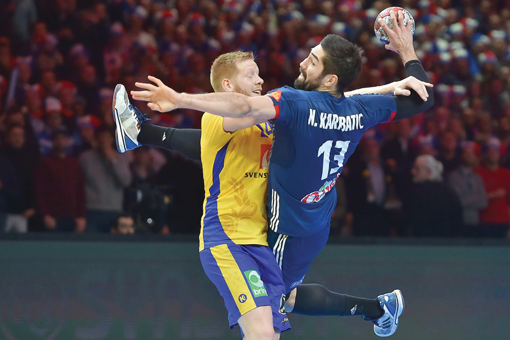 Sweden's Jim Gottfridsson (right) defends against France's Nikola Karabatic during their 25th IHF Men's World Championship 2017 quarter final   on Tuesday.