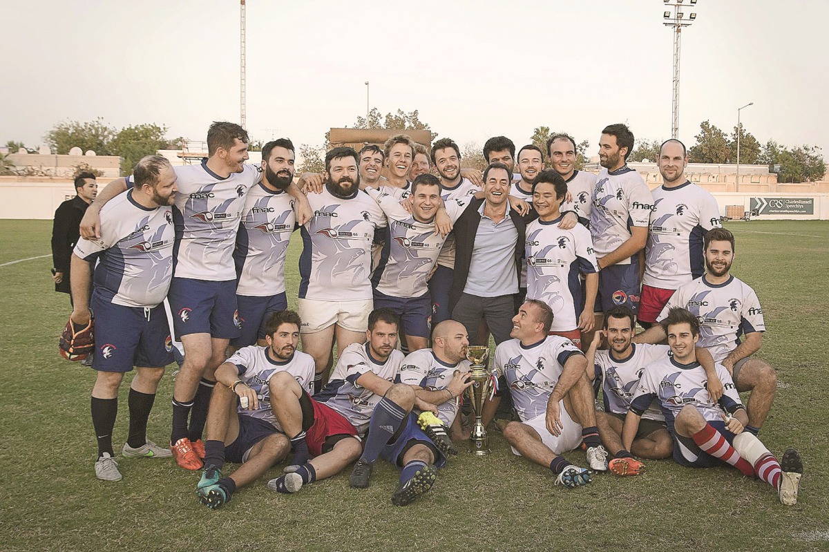 Blue Phoenix winners of the Qatar Rugby XV Domestic League title pose for a picture in Doha on Friday night. Bottom: Action from the final match between Blue Phoenix and DRFC.