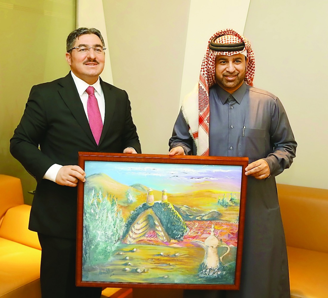 Katara General Manager Dr. Khalid bin Ibrahim Al Sulaiti (right) presents a painting as a memento to Turkish Ambassador Ahmet Demirok yesterday at Katara.