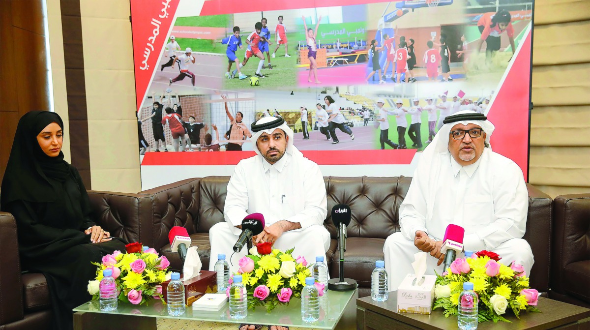 Ali Al Hitmi (right), Secretary General of the Qatar School Sports Association (QSSA) announcing details about the Schools Olympic Program at a press conference in the presence of Abdulrahamn Al Muftah, the Executive Director of QSSA, and Fajar Al Kubesi,