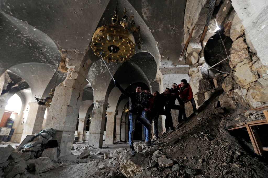 People take a selfie inside Aleppo's Umayyad mosque, Syria January 31, 2017. Picture taken January 31, 2017. REUTERS/Omar Sanadiki
