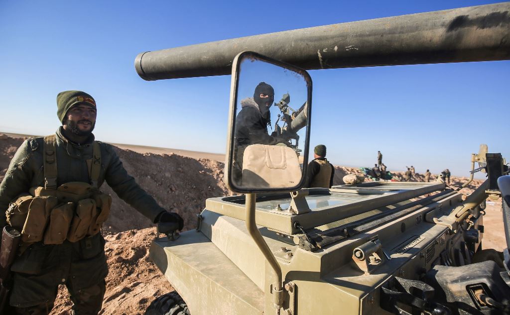 A picture taken on February 18, 2017 shows the reflection of a fighter manning a gun through the mirror of heavily-armed vehicle near the frontline village of Ayn al-Hisan, on the outskirts of Tal Afar west of Mosul, where Iraqi forces are preparing for t