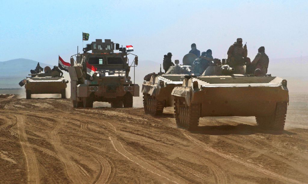 Iraqi forces armoured vehicles, supported by the Hashed al-Shaabi (Popular Mobilisation) paramilitaries, advance towards the village of Sheikh Younis, south of Mosul, after the offensive to retake the western side of the city from Islamic State (IS) group