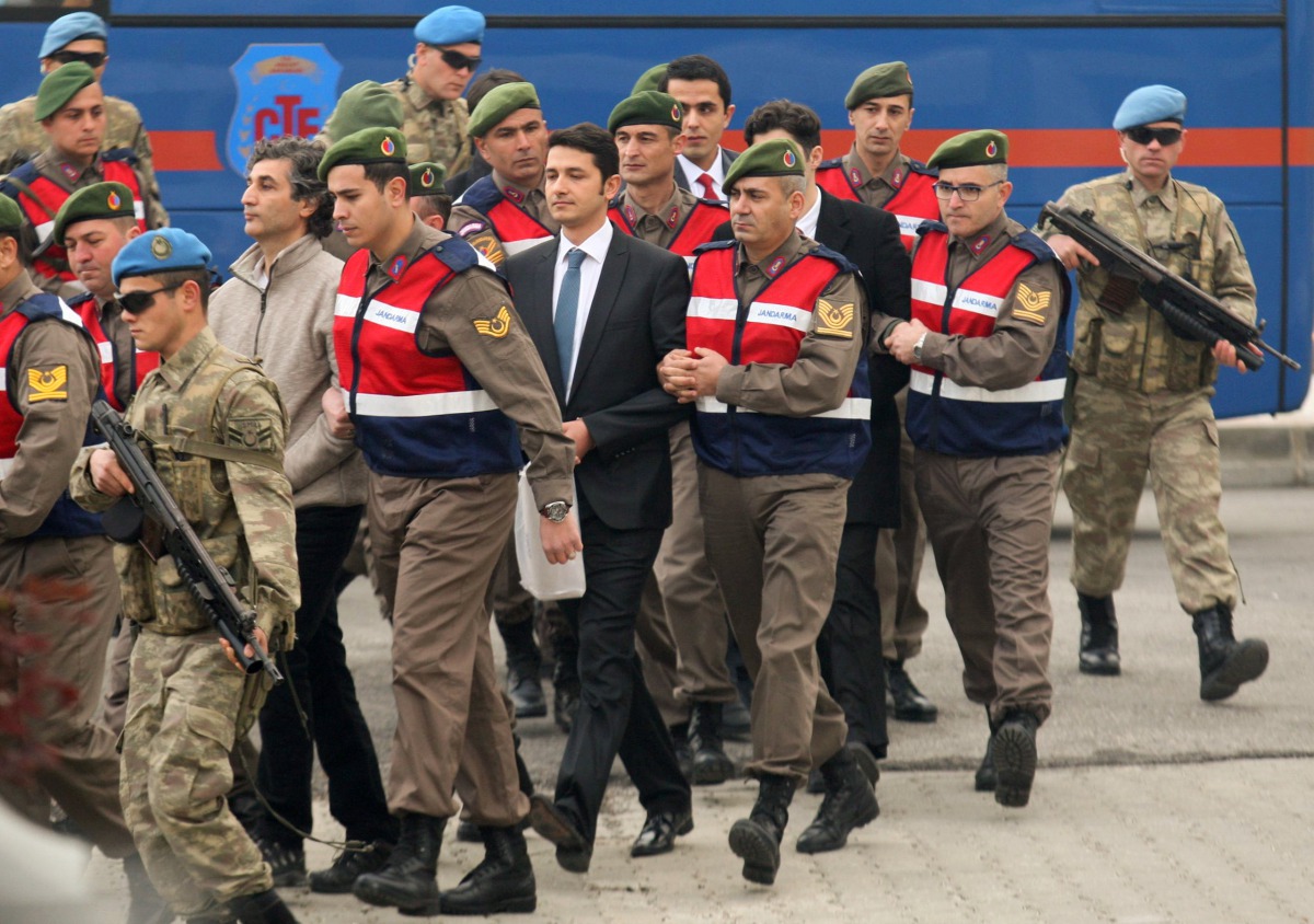 Turkish soldiers accused of attempting to assassinate President Tayyip Erdogan on the night of the failed last year's July 15 coup, are escorted by gendarmes as they arrive for the first hearing of the trial in Mugla, Turkey, February 20, 2017. REUTERS/Ke