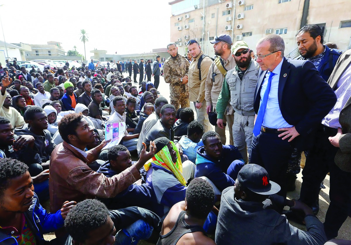 UN envoy to Libya, Martin Kobler, talks to illegal migrants during a visit at a detention centre in the Libyan capital Tripoli, yesterday.
