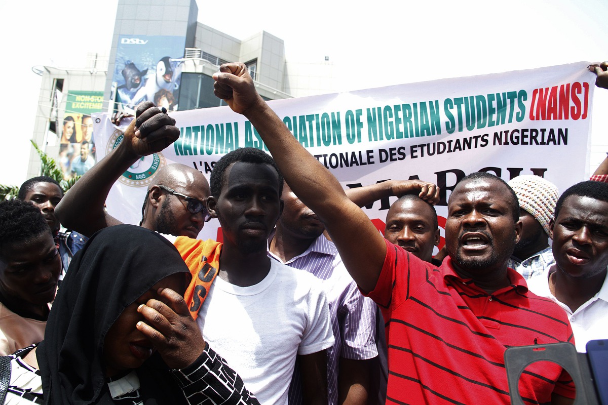 Nigerian students shout slogans against South Africa as they protest outside the South African Digital Satellite TV's (DSTV) Nigerian headquarters in Abuja against the recent spike in attacks targeting foreign nationals in South Africa on February 23, 201