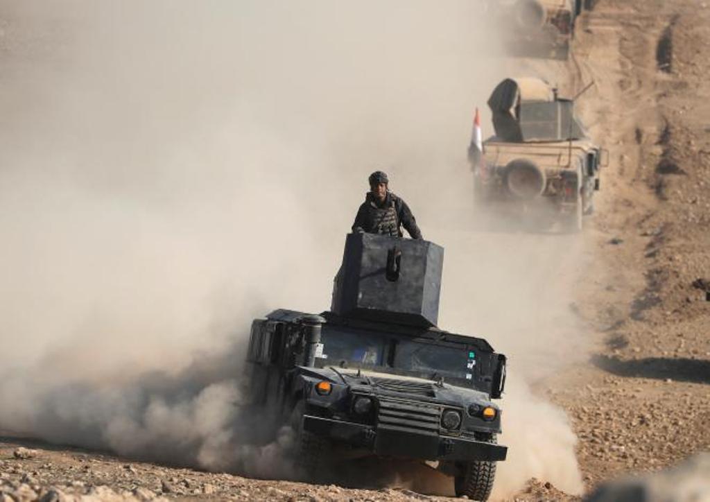 An Iraqi Special Forces soldier stands on top of a vehicle in a desert south of Mosul, Iraq February 24, 2017. REUTERS/Goran Tomasevic.