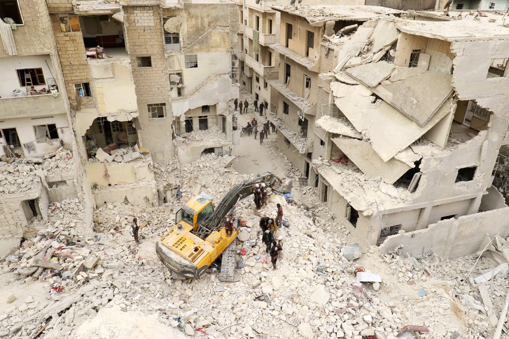 Civil defence members work at a site hit at dawn by an airstrike in the rebel-controlled town of Ariha in Idlib province, Syria, February 27, 2017. REUTERS/Ammar Abdullah
