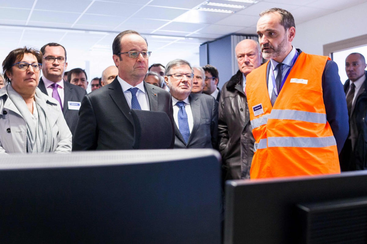 French President Francois Hollande (3rd L) visits a control room as he attends the inauguration of the new 