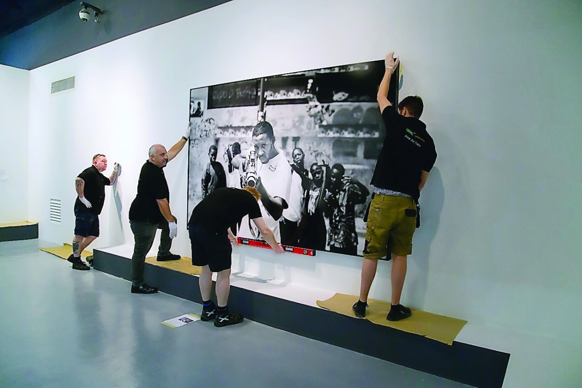 People getting ready for the opening of the retrospective by the celebrated French artist, JR, at QM Gallery in Katara.