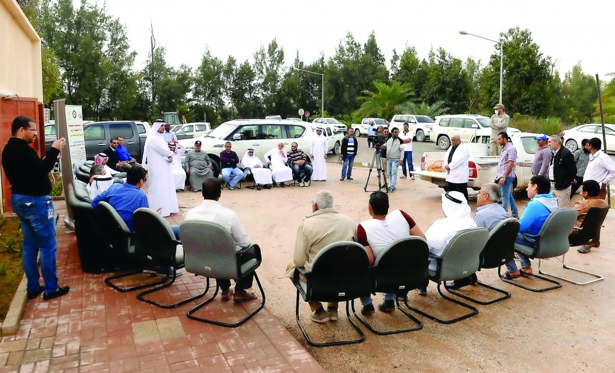 Officials and farmers during an awareness programme about artificial liquid pollination of date palm.