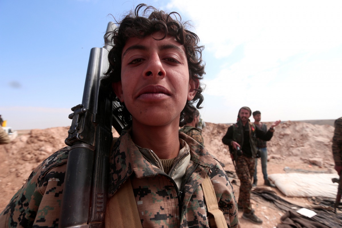  A young Syrian Democratic Forces(SDF) fighter poses for a picture with his weapon north of Raqqa city, Syria March 8, 2017. REUTERS/Rodi Said