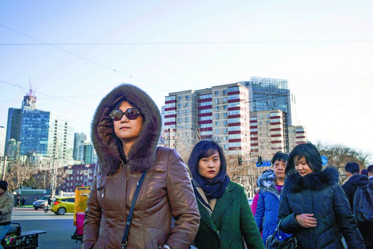 People walking in the street on their way to work in Beijing.