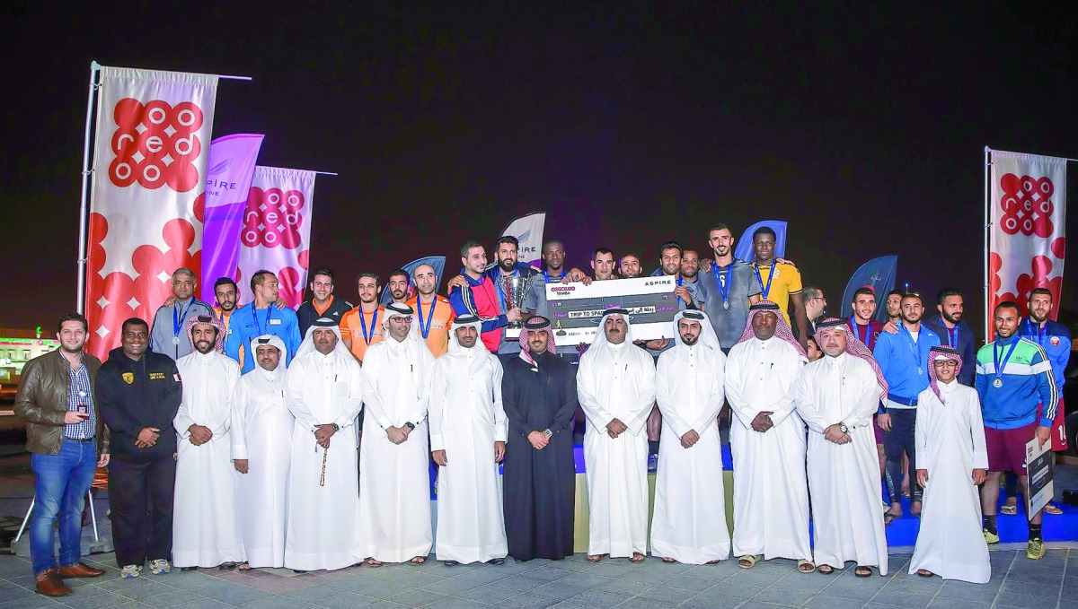 Organisers of AZF and Ooredoo Qatar pose with the winning team.