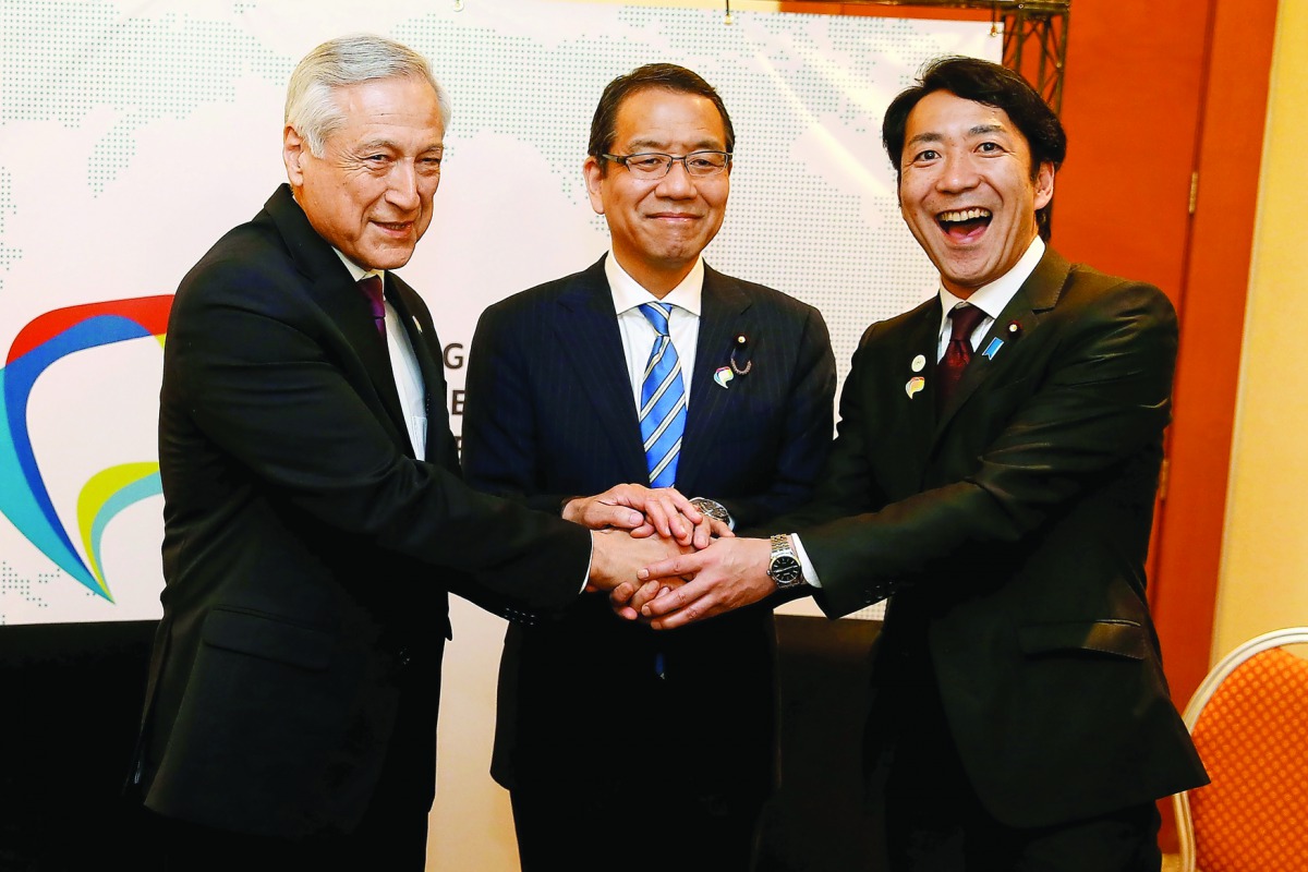 Chile's Foreign Minister Heraldo Munoz (L) shakes hands with Japan's State Cabinet Office Minister Takao Ochi (C) and Japan's Parliamentary Vice-Minister of Economy, Trade and Industry Toshinao Nakagawa during a meeting of the 