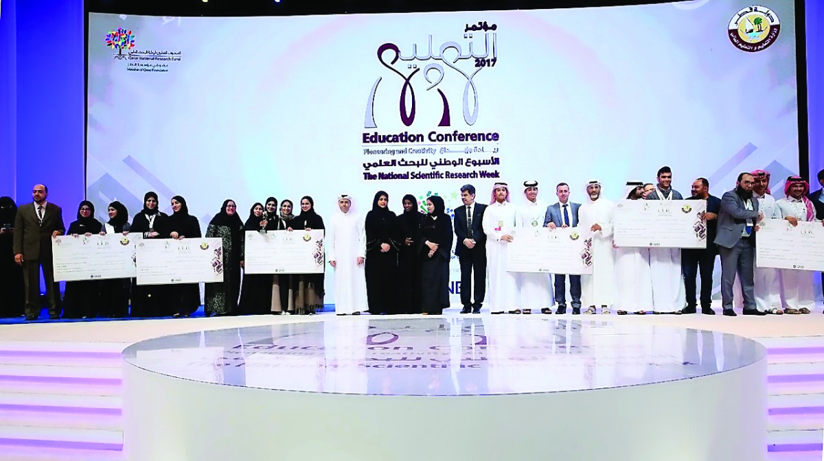 Minister of Education and Higher Education, H E Dr Mohammed Abdul Wahed Ali Al Hammadi, with winners of the National Scientific Researchers Week competition, during the closing ceremony of the Education Conference at QNCC yesterday.