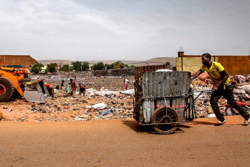 (FILES) This file photo taken on March 08, 2017 shows a garbage scavenger pushing a cart through a dump in Bamako. AFP / SEBASTIEN RIEUSSEC
