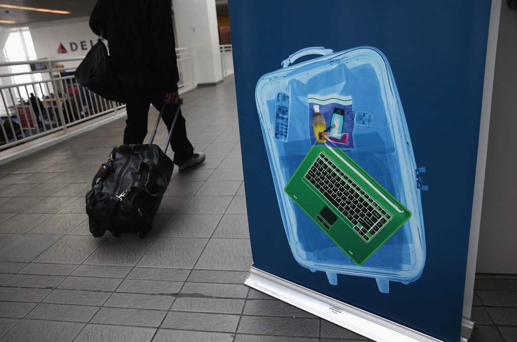 (FILES) This file photo taken on January 26, 2014 shows a traveler walking past a newly-opened TSA Pre-check application center at Terminal C of the LaGuardia Airport on Once approved, travelers can use special expidited Precheck security lanes.  AFP / JO