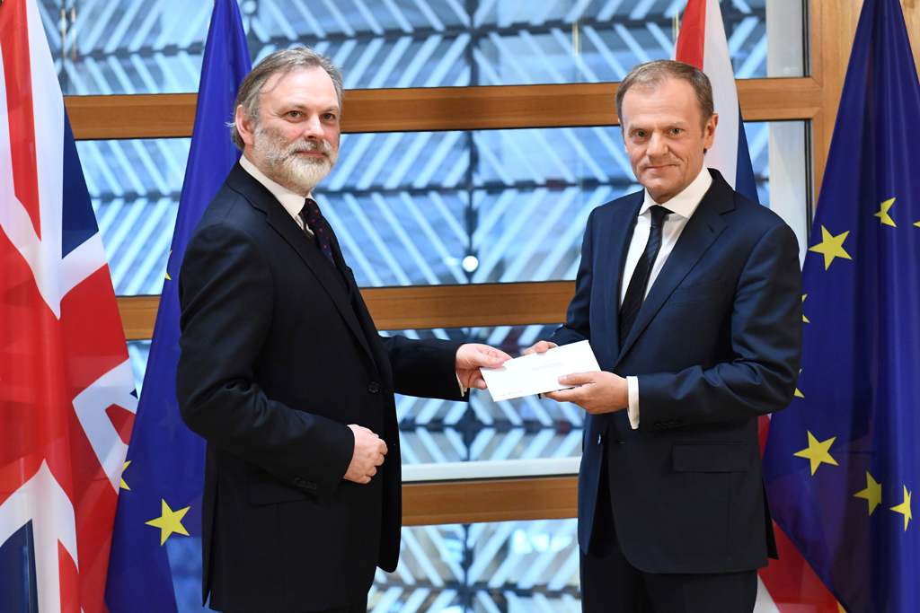 Britain's ambassador to the EU Tim Barrow delivers British Prime Minister Theresa May's formal notice of the UK's intention to leave the bloc under Article 50 of the EU's Lisbon Treaty to European Council President Donald Tusk in Brussels on March 29, 201