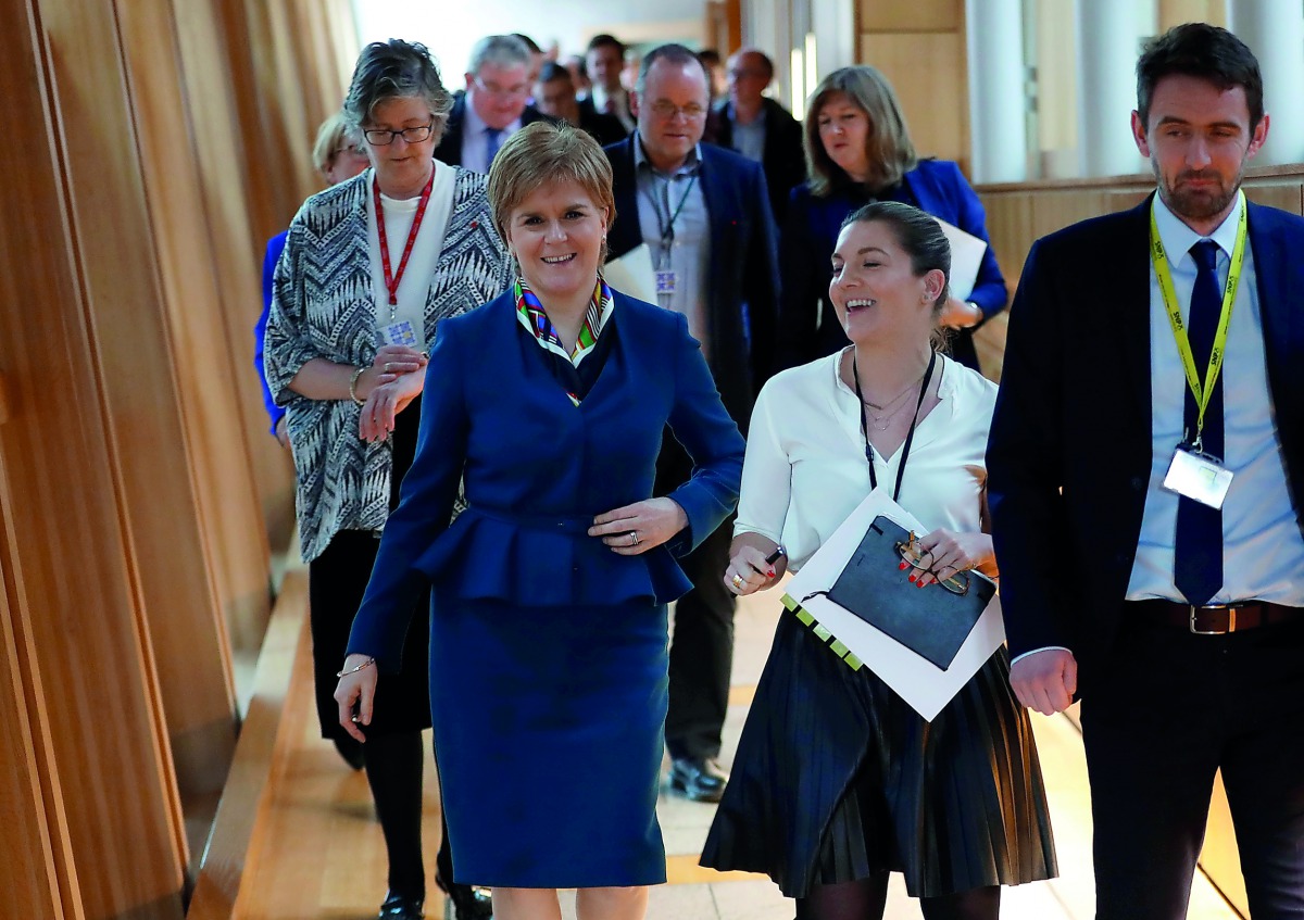 Scotland's First Minister Nicola Sturgeon returns from the chamber in Parliament in Edinburgh, Scotland, Britain March 29, 2017. REUTERS/Russell Cheyne