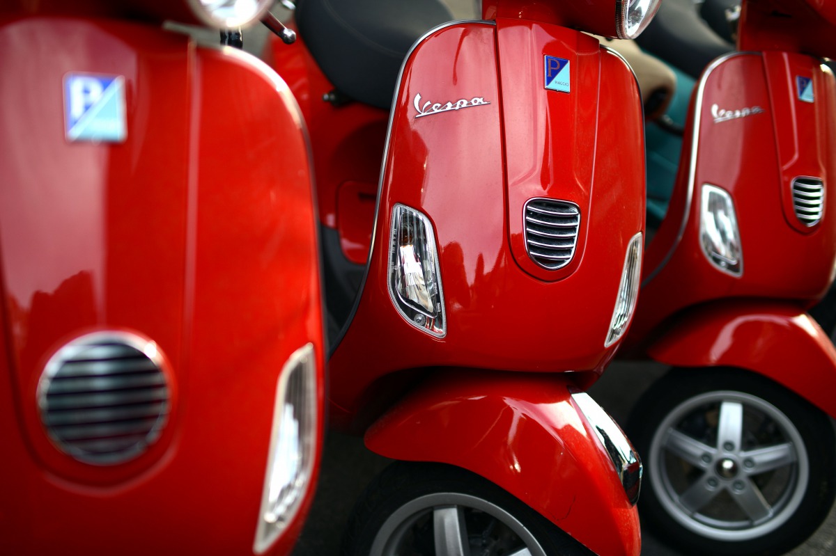Red Vespa parked in a street of Rome, on December 9, 2013.  AFP / Gabriel Bouys

