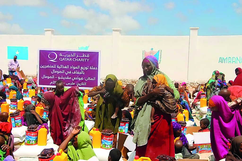 Women and children receiving aid supplied by Qatar Charity in drought-hit Somalia.