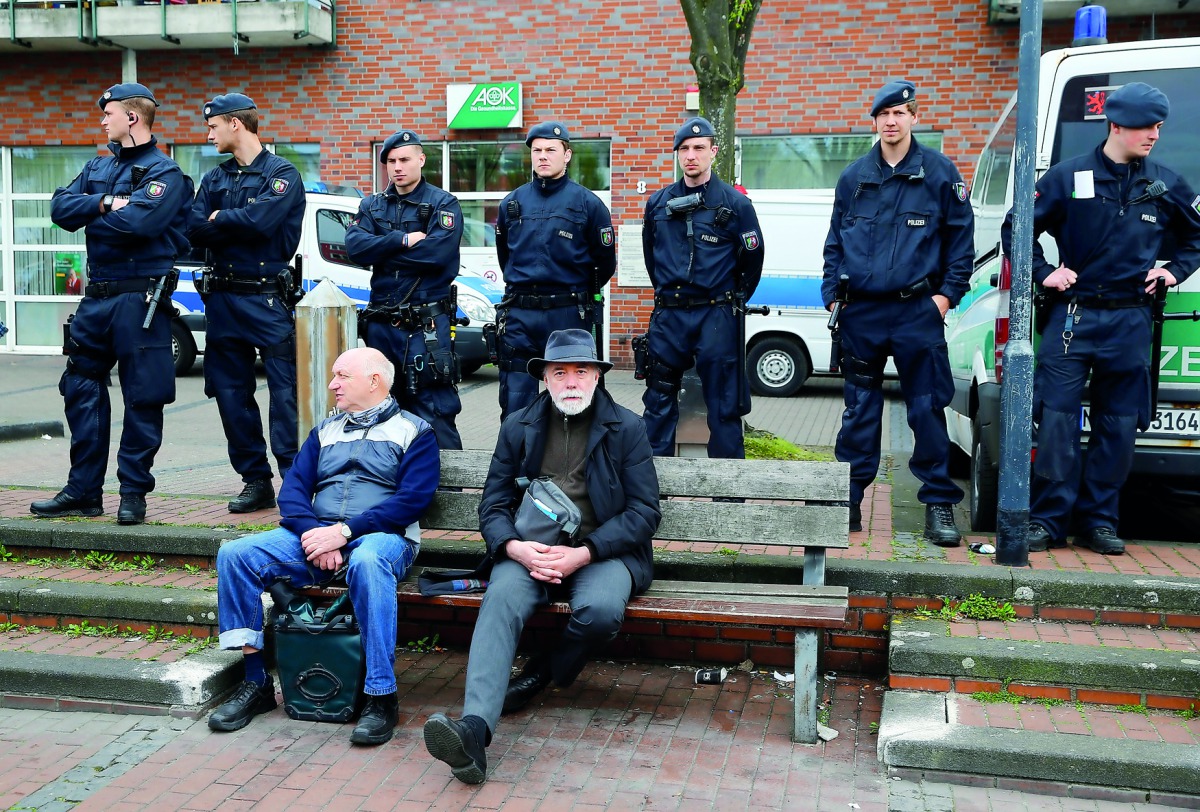 German riot police stand guard during the anti-immigration party Alternative for Germany (AfD) election campaign launch for the upcoming North Rhine-Westphalian federal state elections in Essen, Germany, yesterday.