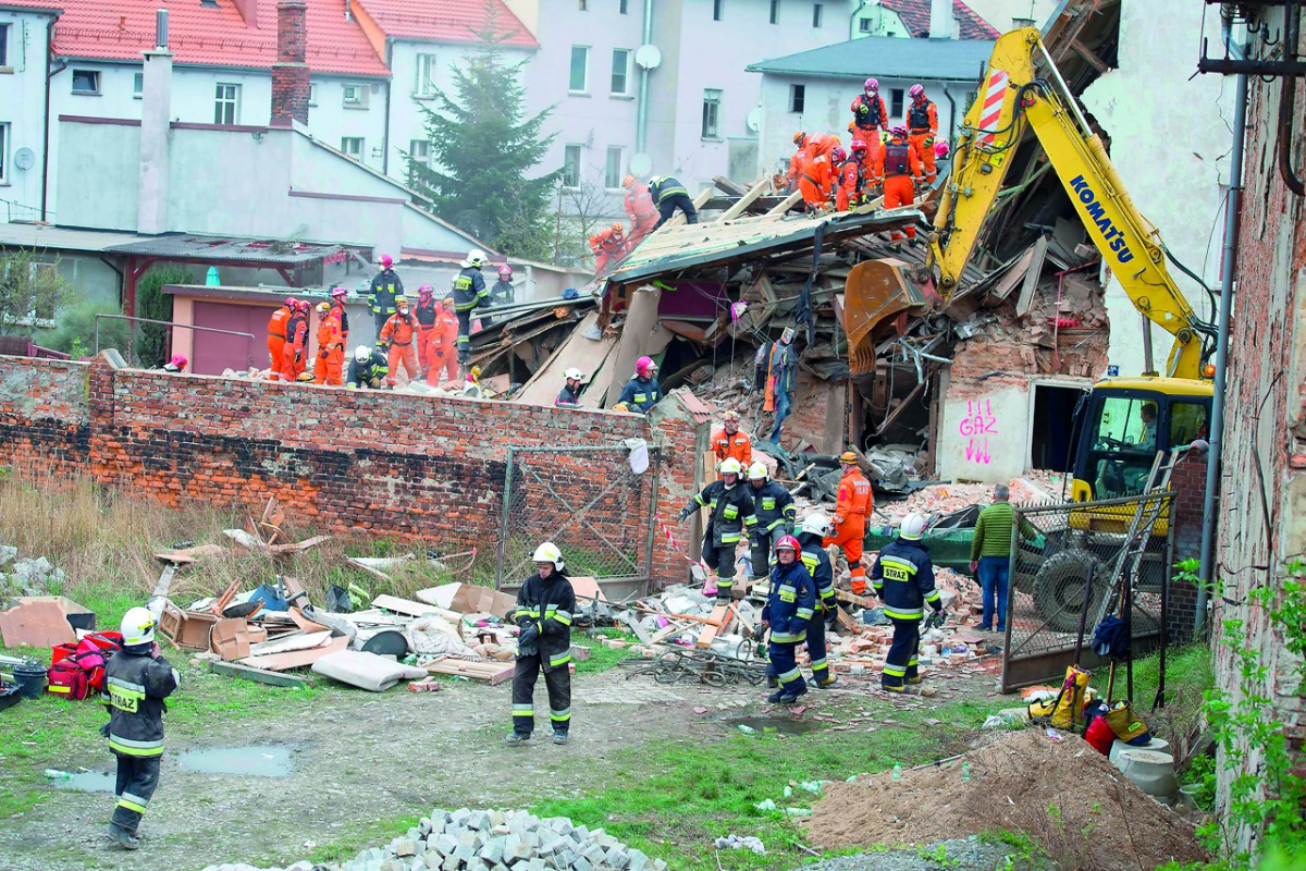 Rescuers search after a building collapsed burying several people in Swiebodzice, yesterday.