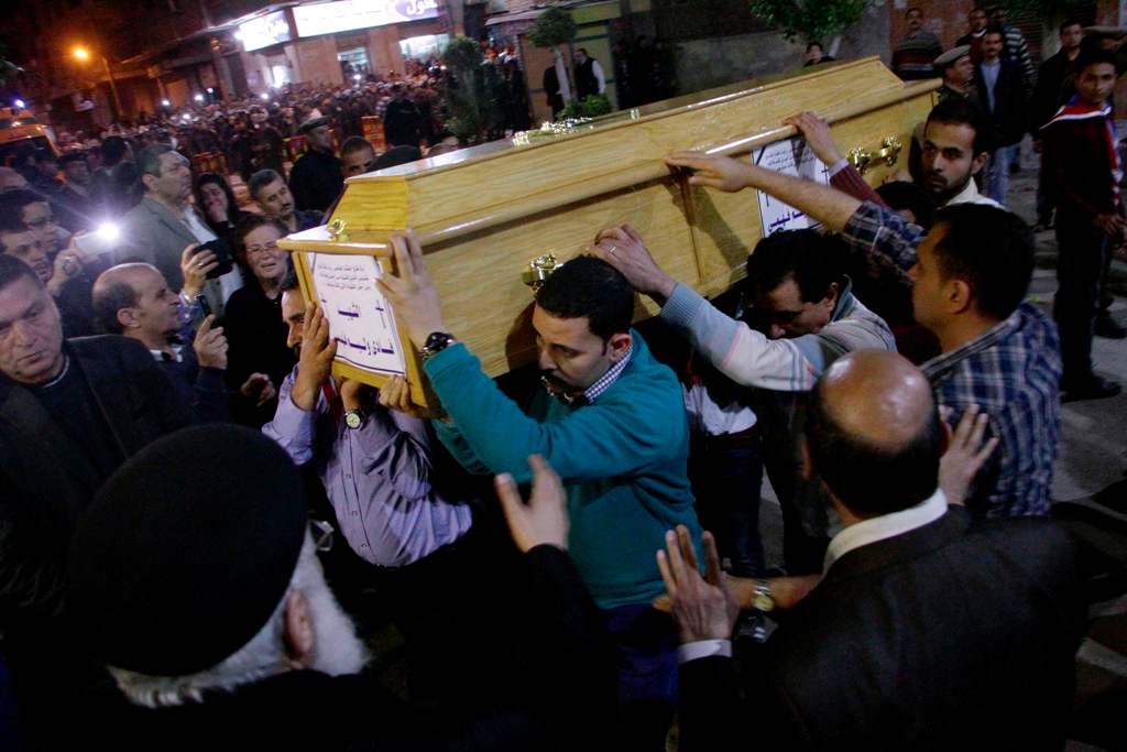 Graphic content / Egyptian Christians carry a coffin during the late night funeral of the victims of a blast which killed worshippers attending Palm Sunday mass at the Mar Girgis Coptic Orthodox Church in the Nile Delta City of Tanta, 120 kilometres (75 m