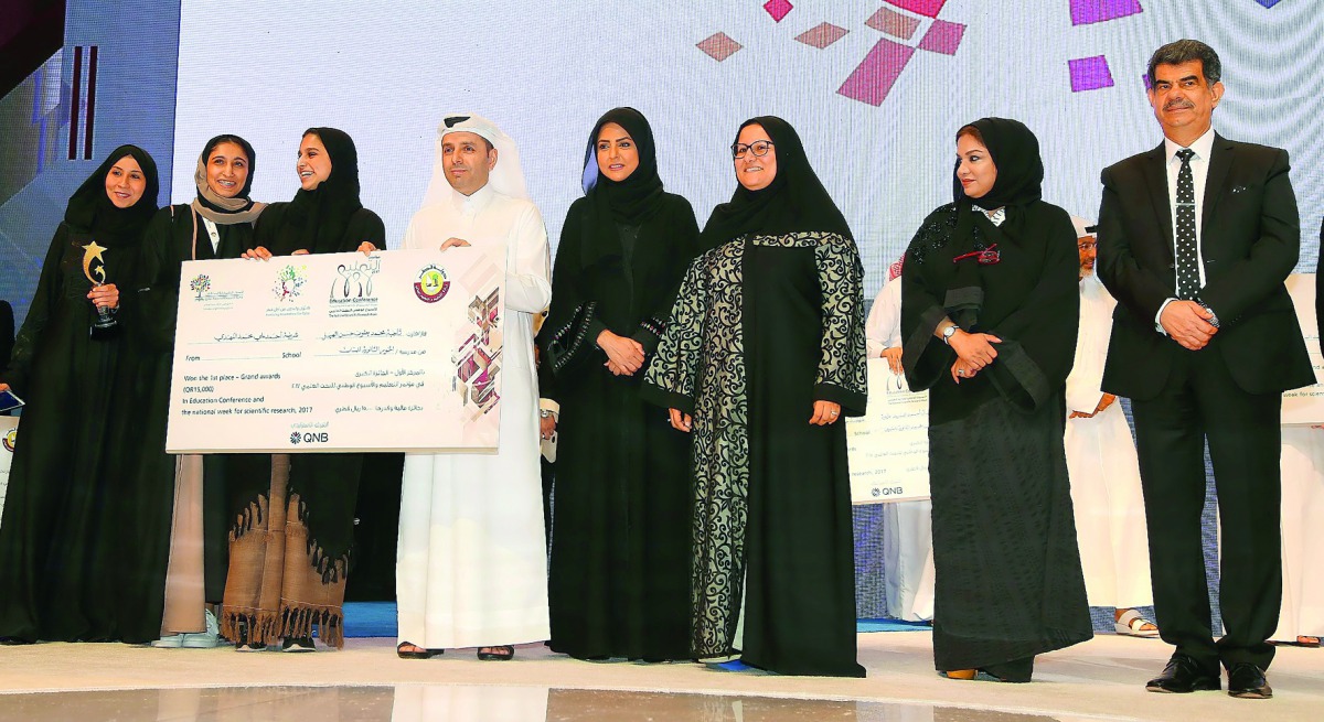 H E Dr Mohammed Abdul Wahed Ali Al Hammadi, Minister of Education and Higher Education, and Dr Abdul Sattar Al Taie, Executive Director, QNRF, with the winners of the National Scientific Research Competition Grand Awards.