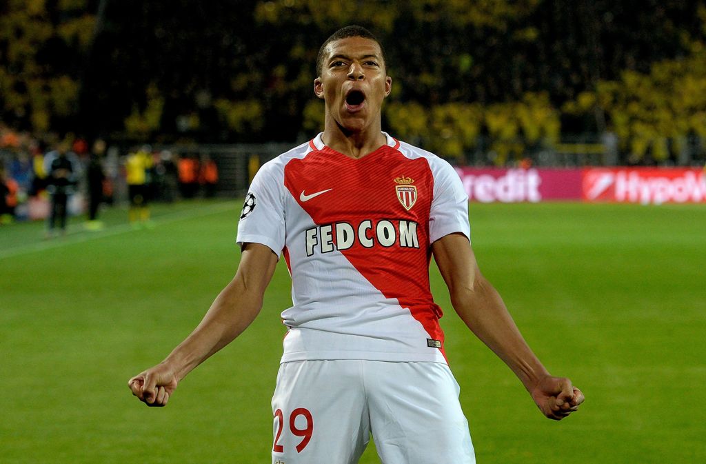 TOPSHOT - Monaco's French forward Kylian Mbappe Lottin reacs after scoring during the UEFA Champions League 1st leg quarter-final football match BVB Borussia Dortmund v Monaco in Dortmund, western Germany on April 12, 2017.  AFP / Sascha Schuermann
