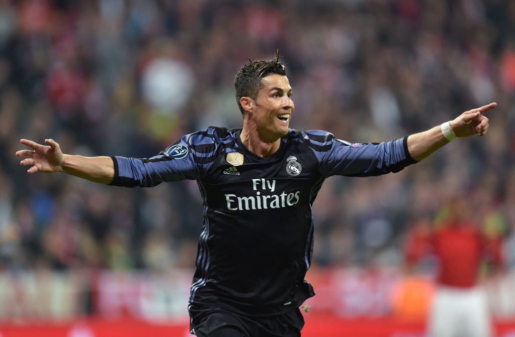 Real Madrid's Portuguese forward Cristiano Ronaldo celebrates after scoring during the UEFA Champions League 1st leg quarter-final football match FC Bayern Munich v Real Madrid in Munich, southen Germany on April 12, 2017.   AFP / Christof STACHE
