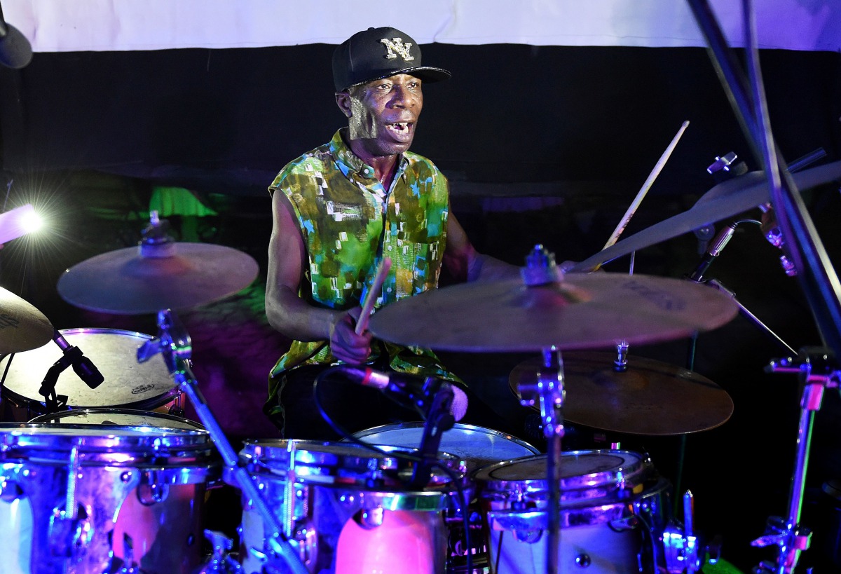 Ivorian jazz drummer Paco Sery performing on a stage during an homage to the victims of March 13, 2016 terror attack at the resort of Grand Bassam, east of Abidjan on March 12, 2017. AFP / Sia Kambou