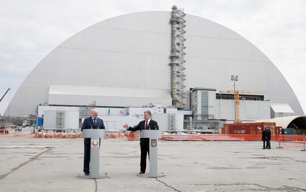 Presidents of Ukraine Petro Poroshenko (R) and Belarus Alexander Lukashenko attend a commemoration ceremony, which marks the anniversary of the nuclear disaster, near a New Safe Confinement (NSC) structure over the old sarcophagus covering the damaged fou