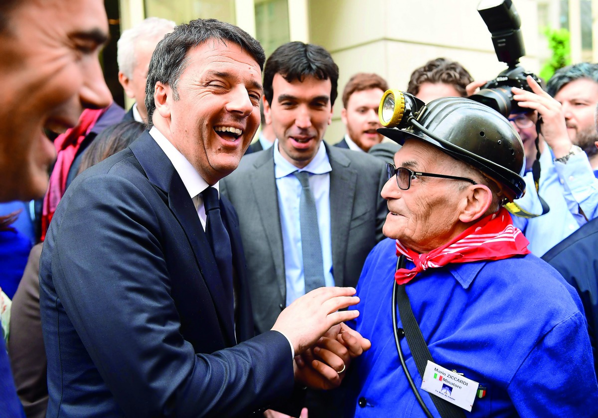 Former Italian prime minister Matteo Renzi (left) meets Mario Zicardi, an old Italian miner residing in Belgium, as Renzi is campaigning for the Italian Democratic Party leadership, in Brussels, yesterday.