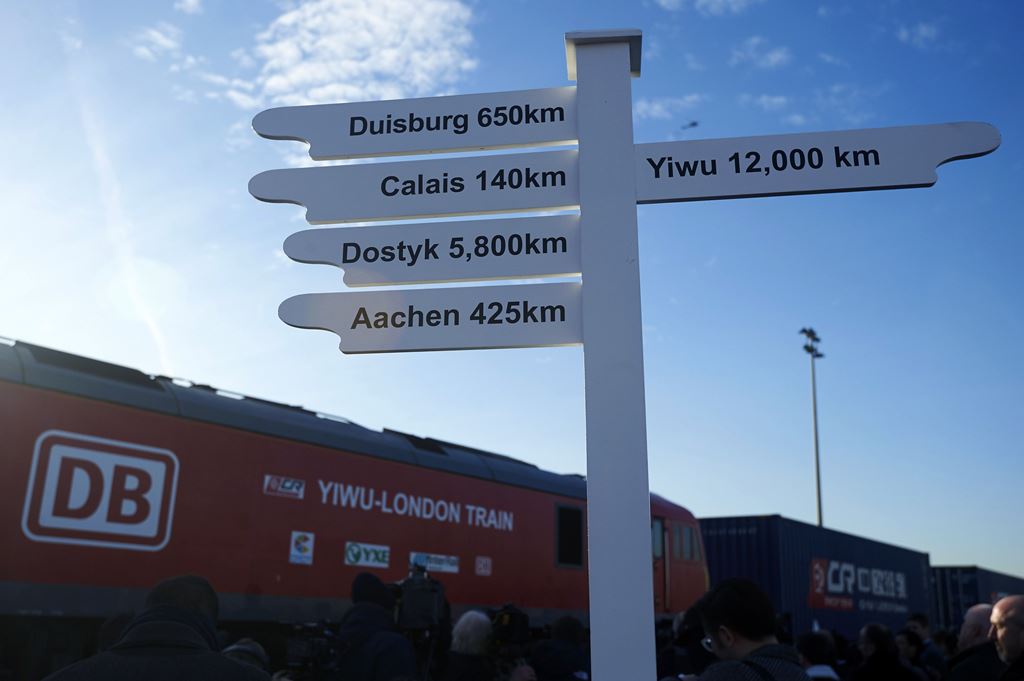 FILES- This file photo taken on January 18, 2017 shows a sign showing the distance in kilometers to various destinations as a freight train transporting containers laden with goods from China, arrives at DB Cargo's London Eurohub rail freight depot in Bar