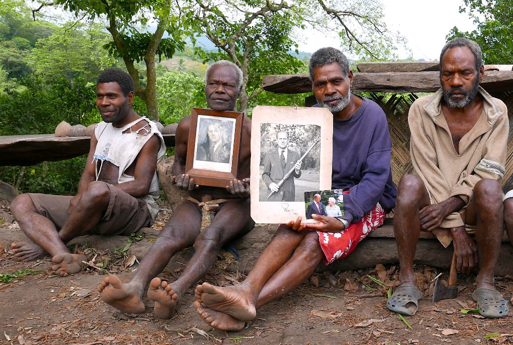 Chief Jack Malia (2nd R) from the Imanourane Tribe holds photographs of Britain's Prince Philip as he sits next to other villagers in the village of Younanen on Tanna Island in the Pacific island nation of Vanuatu, May 6, 2017. REUTERS/Jill Gralow