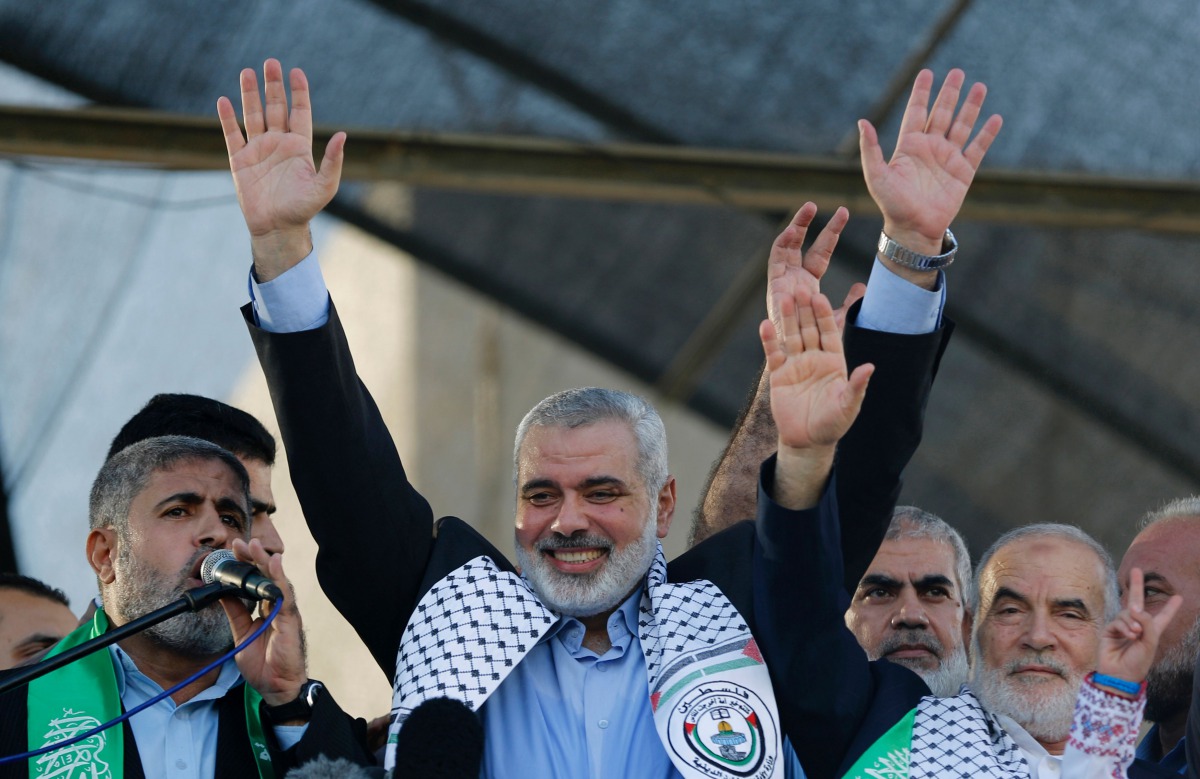 This file photo taken on August 27, 2014 shows Hamas leader in the Gaza Strip Ismail Haniya (C) waving to the crowd during a rally in Gaza City following a deal hailed by Israel and the Islamist movement as 'victory' in the 50-day war. AFP / Mohammed Abed