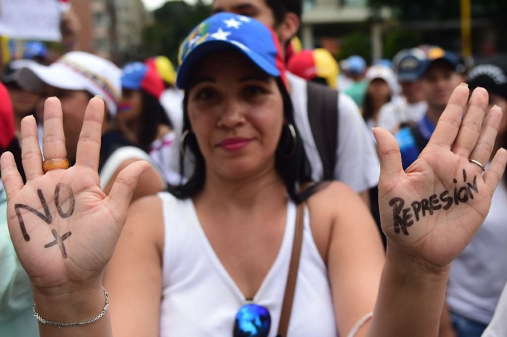 Led by opposition leaders and Lilian Tintori, wife of jailed opposition leader Leopoldo Lopez, thousands of women marched through Caracas to pressure President Nicolas Maduro (AFP Photo/RONALDO SCHEMIDT).