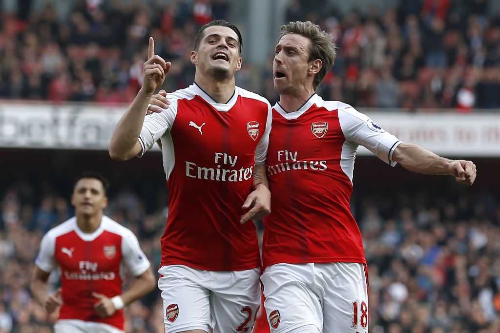 Arsenal's Swiss midfielder Granit Xhaka celebrates with Arsenal's Spanish defender Nacho Monreal (R) after scoring the opening goal of the English Premier League football match between Arsenal and Manchester United at the Emirates Stadium in London on May