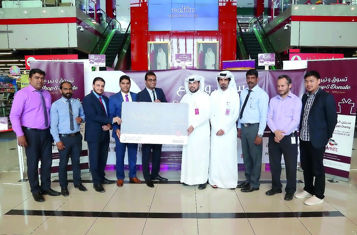 Qatar Charity and Quality Group International officials launching the card at Quality Mall in Al Hilal.