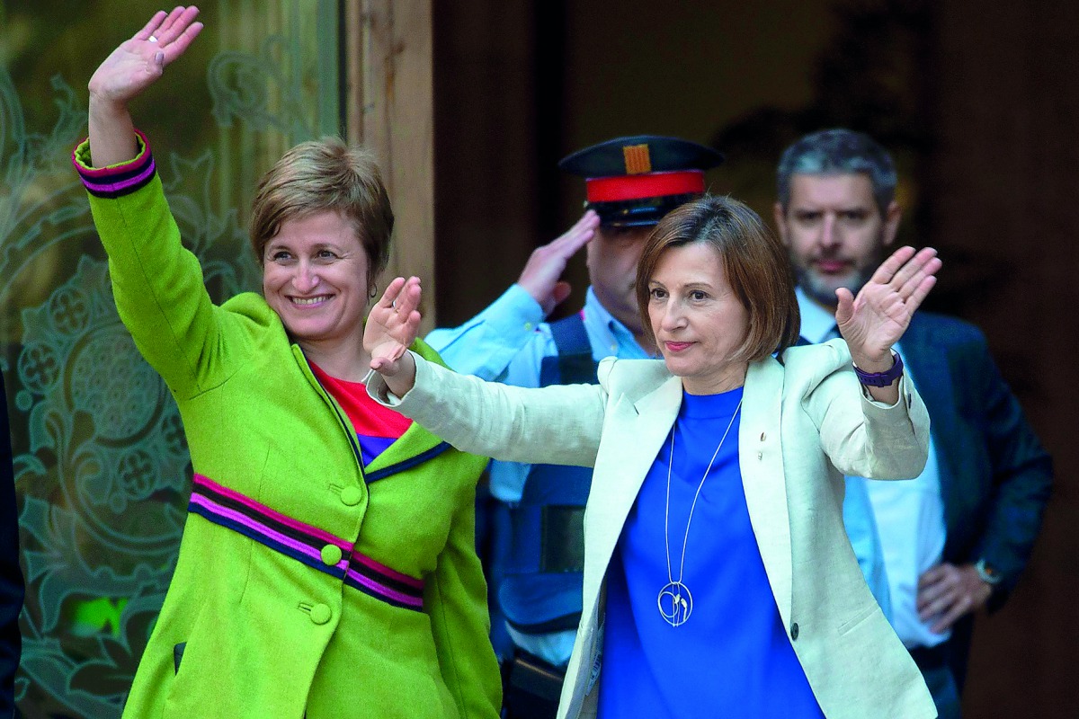 Catalan parliament President Carme Forcadell (R) and member of the Catalan parliament board Anna Simo wave upon their arrival at the TSJC (Superior Court of Catalonia) in Barcelona on May 8, 2017. Forcadell is charged with civil disobedience and misuse of