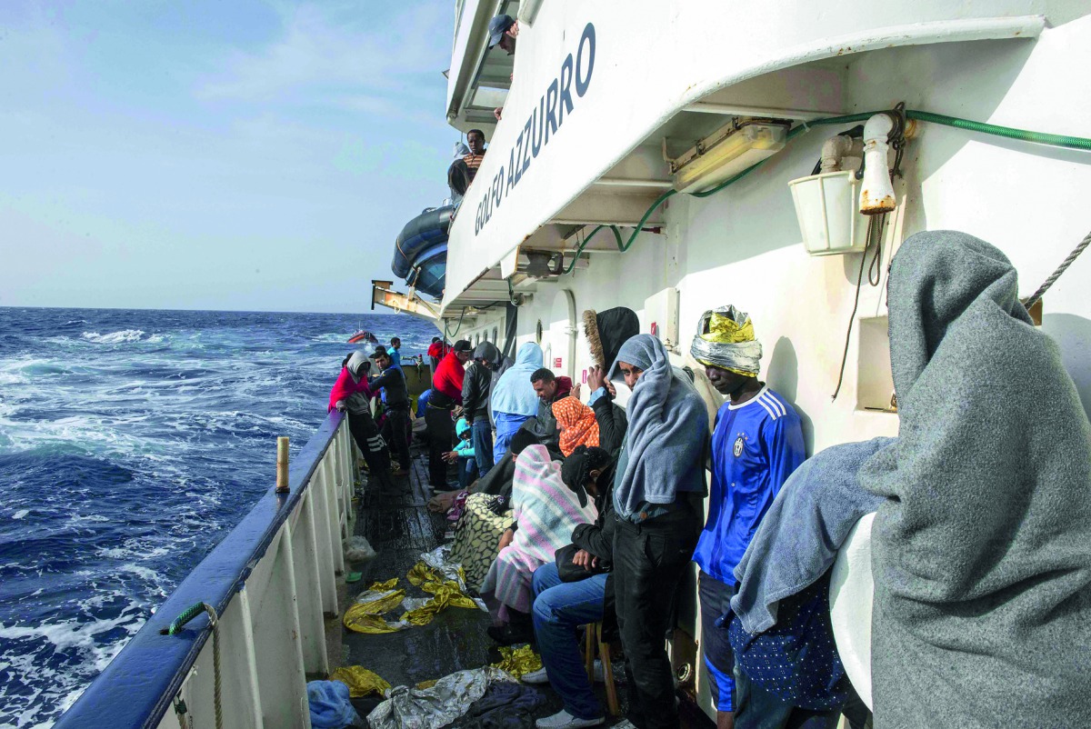 People are seen on board of ship Golfo Azurro during their way to Italy after they were rescued in the Mediterranean Sea in Italy.