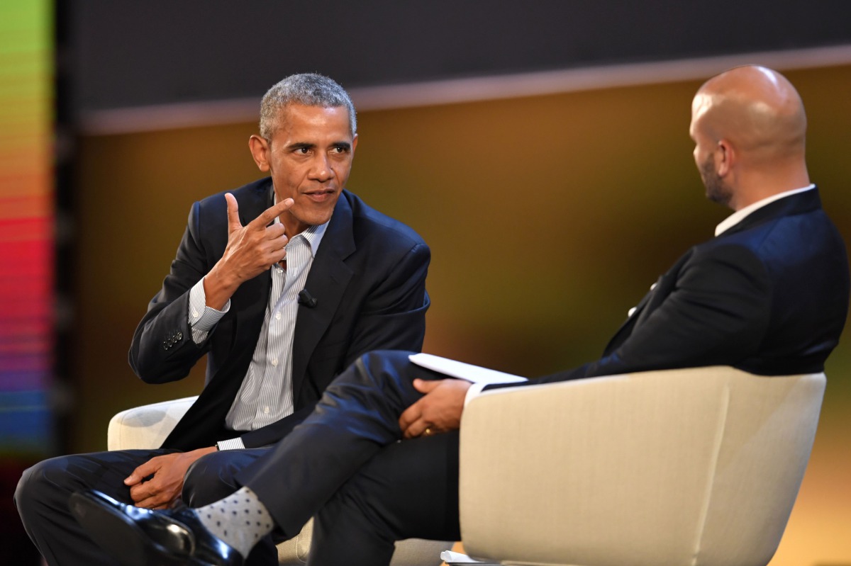 US former President Barack Obama (L) speaks with Sam Kass, food entrepreneur and former White House chef, during the third edition of 